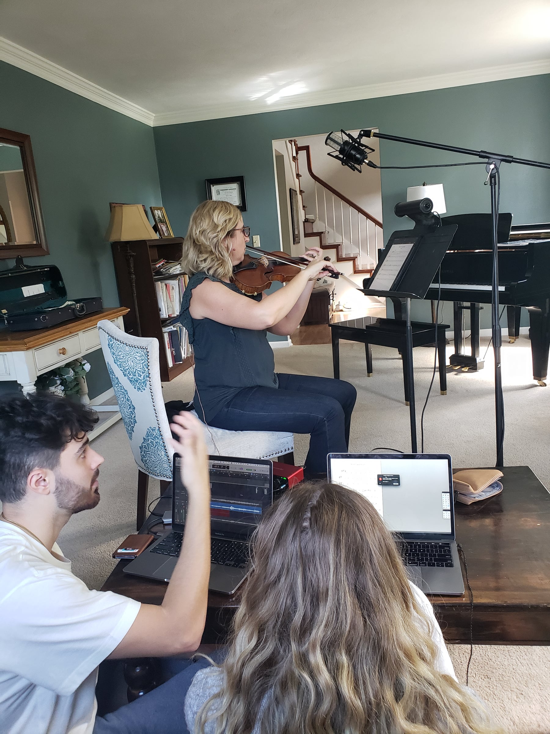 Gretel recording violin at a microphone during a studio session